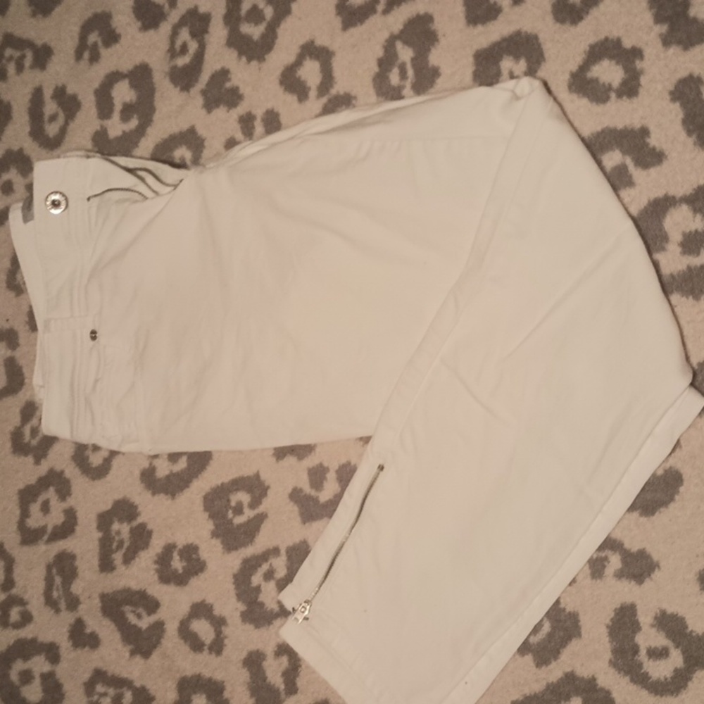 White skinny jeans with zipper ankles.